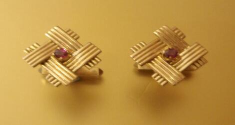 A pair of 9ct gold cufflinks set with a central stone