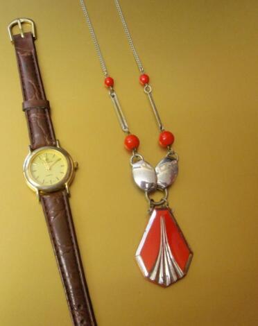 An Art Deco pendant and a quartz watch