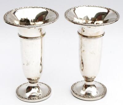 A pair of George V silver stem vases