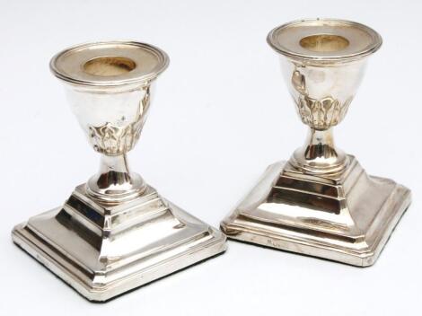 A pair of Edwardian silver dwarf candlesticks