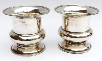 A pair of Edwardian silver bottle coasters or vases