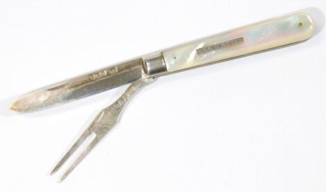 An Edwardian silver and mother of pearl handled campaign folding fork and knife set