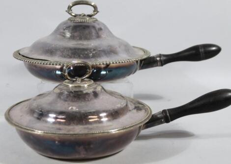 A graduated harlequin pair of early 20thC silver plated serving pans