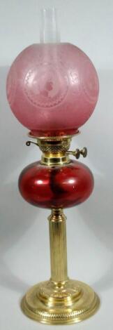 A late Victorian ruby frosted and clear glass and brass oil lamp