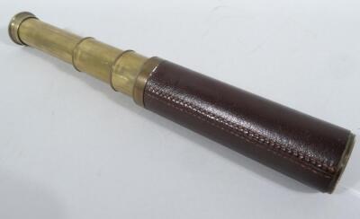 An early 20thC four draw telescope, by Dollond of London, x15 calibre, with leather centre and articulated circular end, (when closed) 18cm wide.