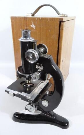 A mid to late 20thC student's microscope in black metal with chrome coloured trim