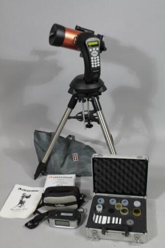 A StarBright XLT Celestron telescope on tripod stand and accessories