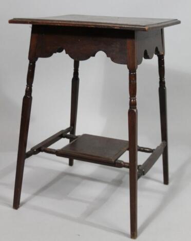 An Edwardian walnut two tier occasional table