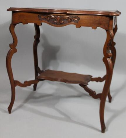 An Edwardian teak two tier occasional table