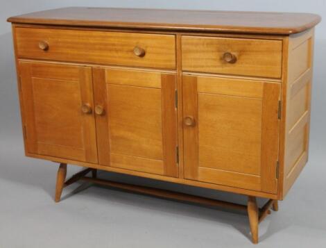 An Ercol type light elm and teak sideboard