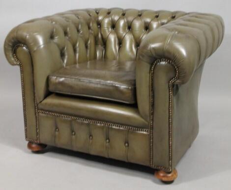 A green leatherette Chesterfield tub shaped chair