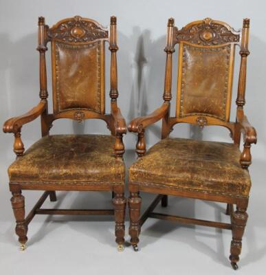 A pair of late 19thC carved oak open armchairs