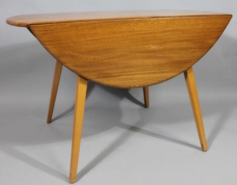 A modern Ercol lightwood drop leaf table