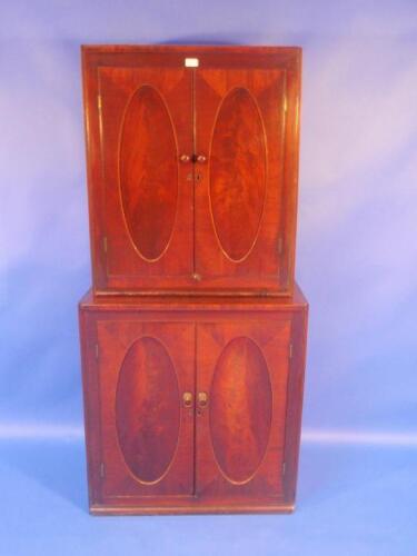 A Georgian mahogany cupboard of two parts