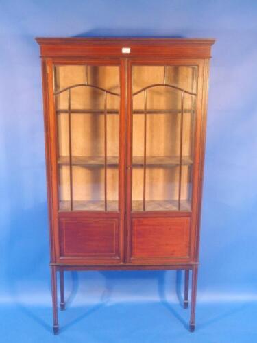 An Edwardian string inlaid mahogany display cabinet with two astragal glazed doors