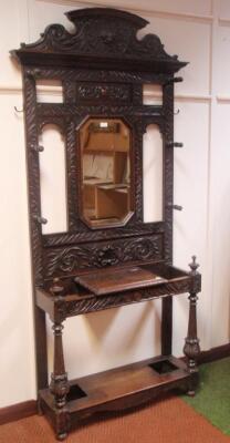 A Victorian carved oak hall stand with mirror back