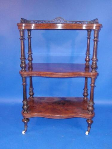 A Victorian figured walnut serpentine whatnot