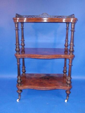 A Victorian figured walnut serpentine whatnot