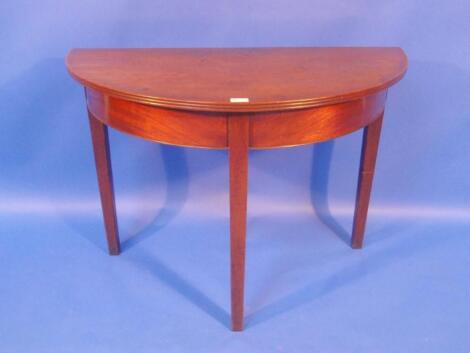 A 19thC mahogany demi-lune table