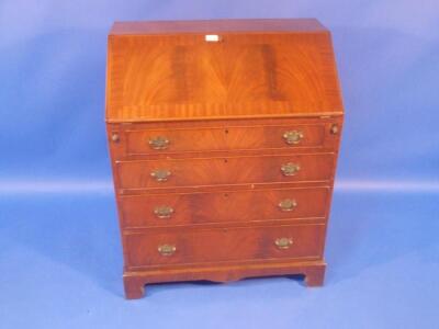 A reproduction flamed mahogany bureau