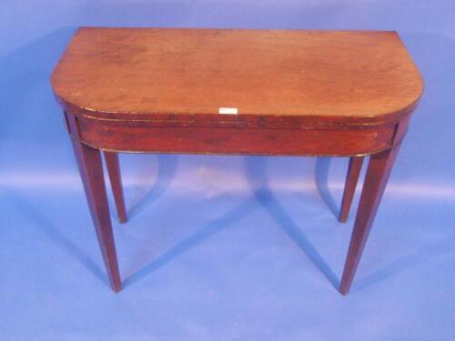 A George III mahogany tea table with rounded rectangular folding top