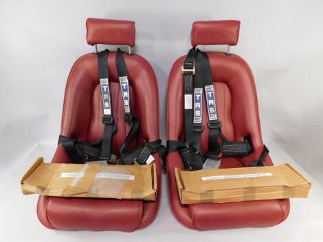 A pair of red leather car rally seats