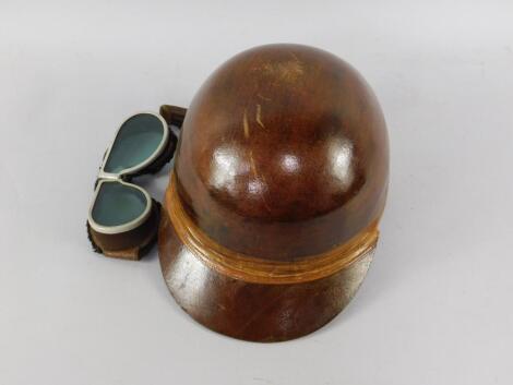 A vintage motorcycling hard cap and goggles