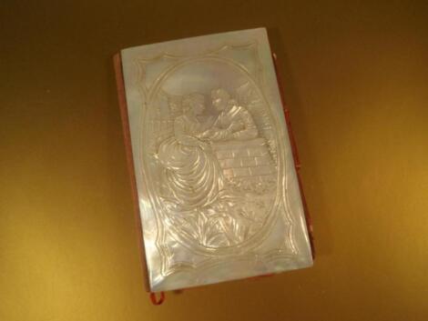 A mother-of-pearl card case/purse with carved scene to front