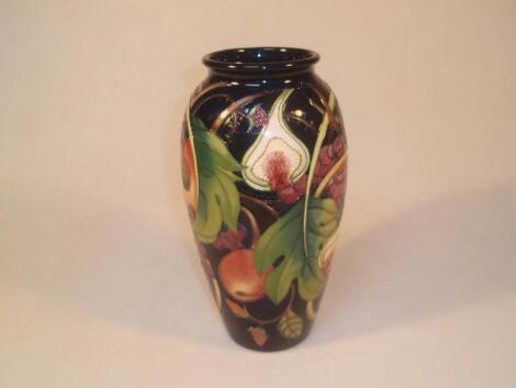 Moorcroft. Modern, a baluster vase decorated with fruit including