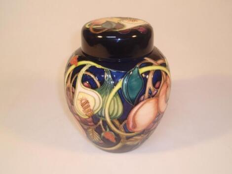 Moorcroft. Modern, lidded ginger jar decorated with fruit including