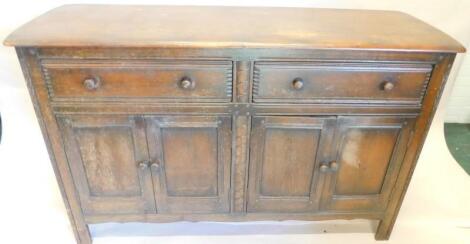 A Priory style oak sideboard