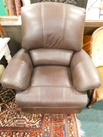 A brown leather electric reclining armchair