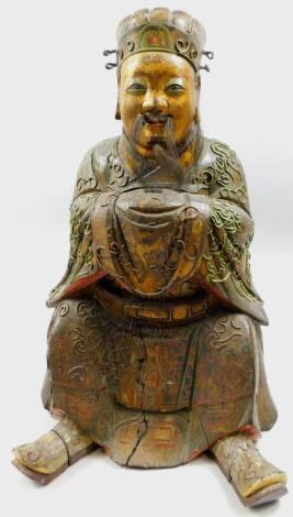 A Chinese polychrome decorated wooden figure of an immortal