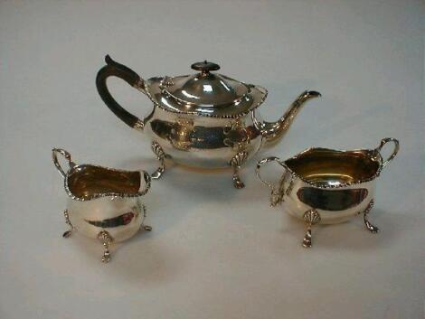 A George V silver three-piece tea service by William Hutton & Sons