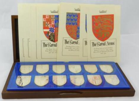 A set of twelve commemorative silver shield shaped medallions