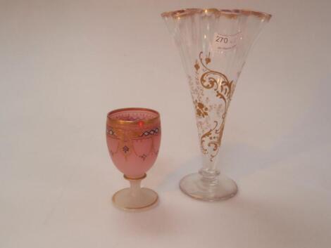 An Edwardian footed fluted vase with floral and gilt decoration together with a pink glass