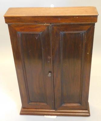 A narrow mahogany cupboard