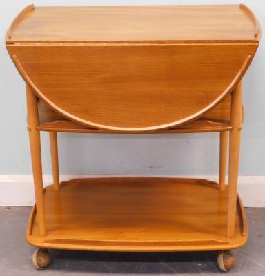 An Ercol light elm three tier drop leaf trolley