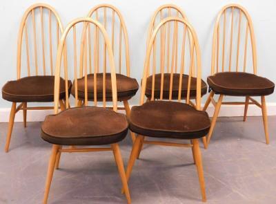 An Ercol light elm drop leaf oval kitchen table and six chairs