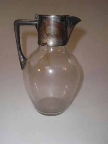 A Christopher Dresser designed claret jug with clear glass body and plated