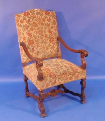 A 19thC carved beech framed open armchair in the Carolean style with tapestry