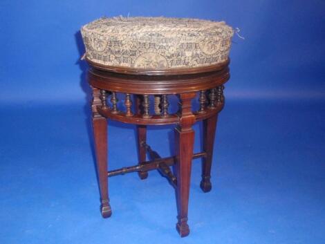 A Victorian rosewood rise and fall circular piano stool with turned gallery