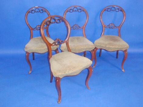 A set of four Victorian walnut cameo back dining chairs with scrolling