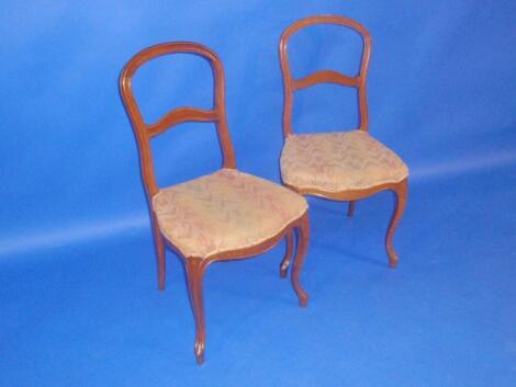 A pair of French style balloon back dining chairs with serpentine seats and cabriole legs