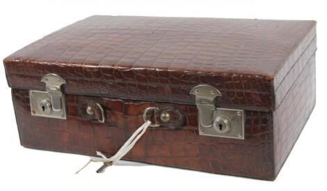 An early 20thC crocodile skin travel case