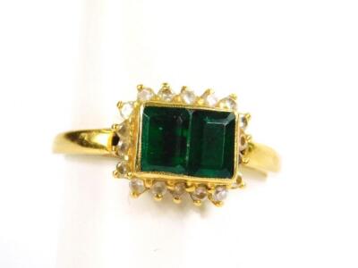 An emerald two stone ring