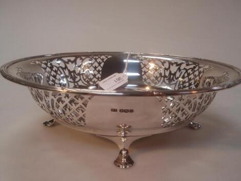 A George VI silver fruit bowl with pieced panels beneath a leaded rim