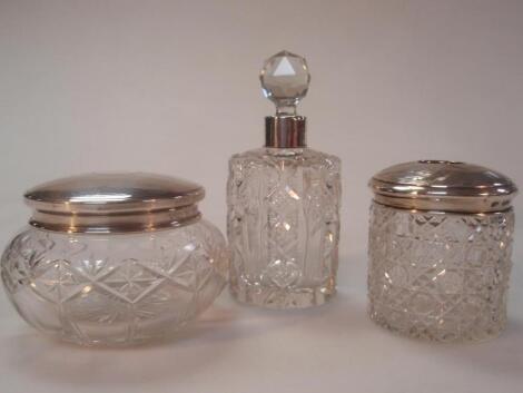 An Edward VII cut glass eau-de-cologne bottle with a faceted stopper and silver collar