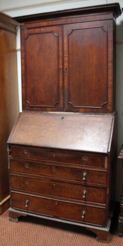 An early 19thC north country oak and mahogany crossbanded bureau bookcase