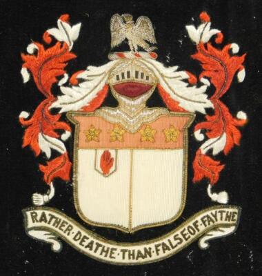 A framed crest in silk and braid